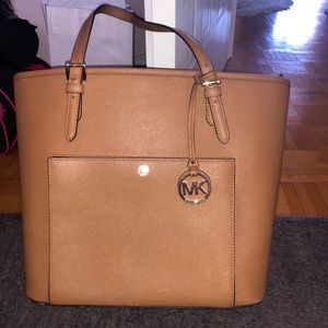 Tan medium sized Michael Kors purse
